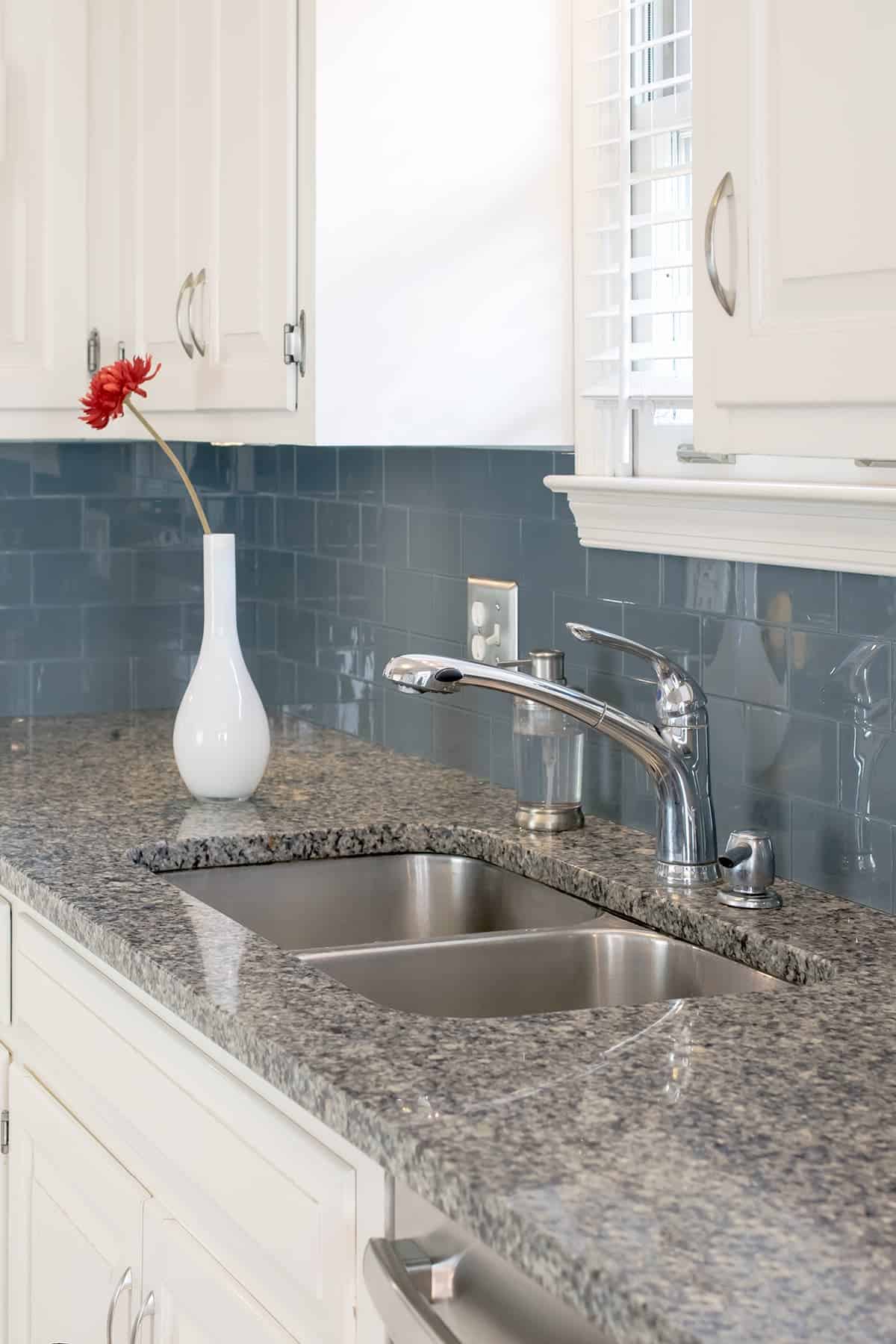 Glass peel and stick kitchen back splash tile in color "storm cloud" with white cabinets.