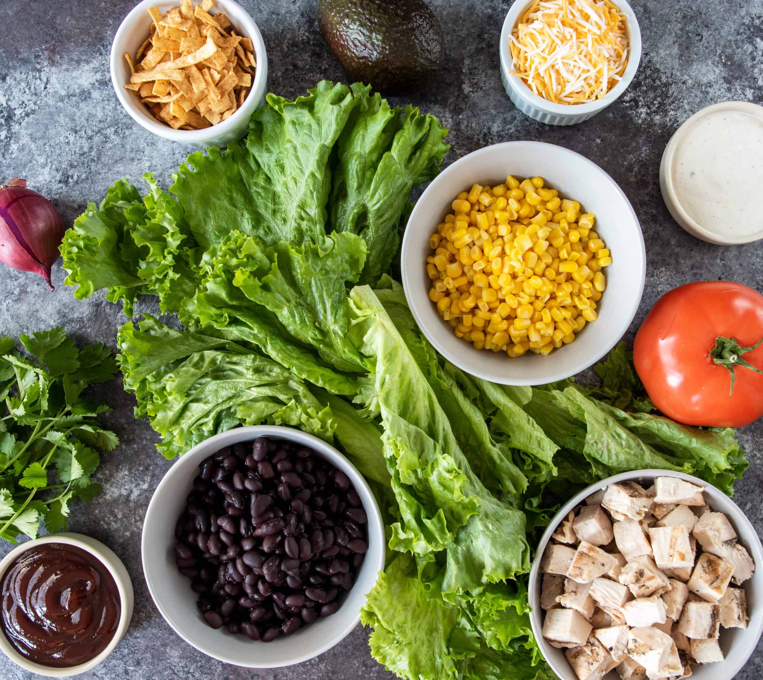 Ingredients to make a Tex-Mex Chicken, corn, and black bean salad with BBQ ranch.