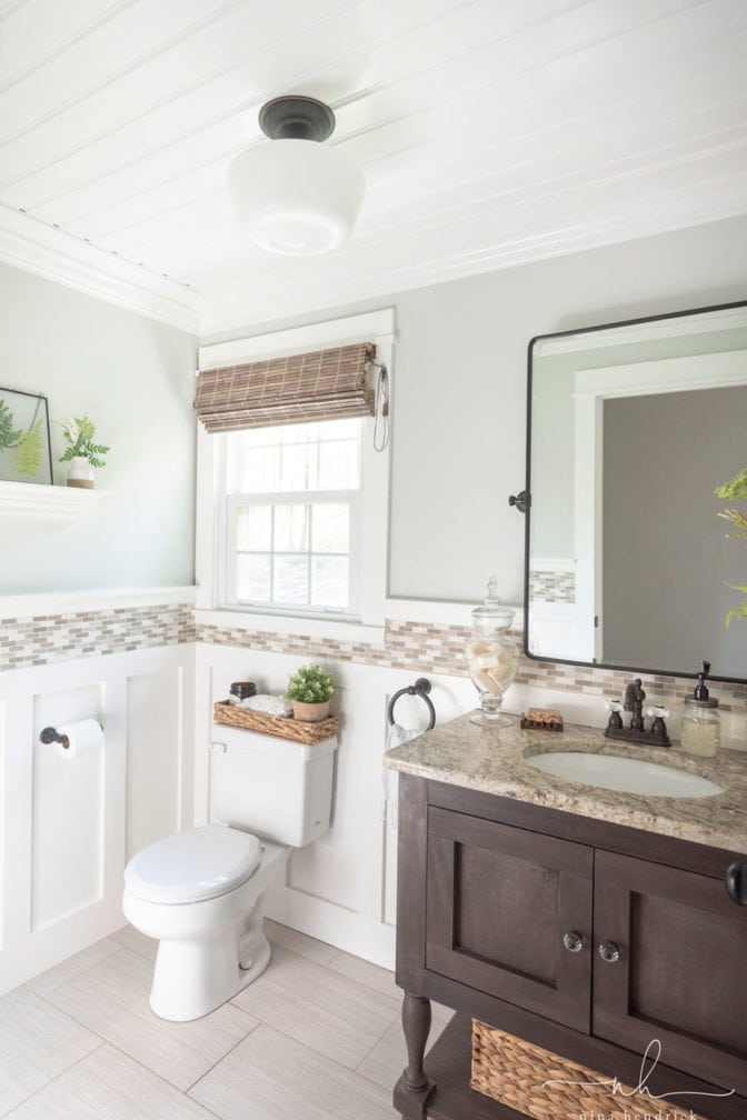 White beadboard ceiling in powder room styled with natural accents and earth tones.