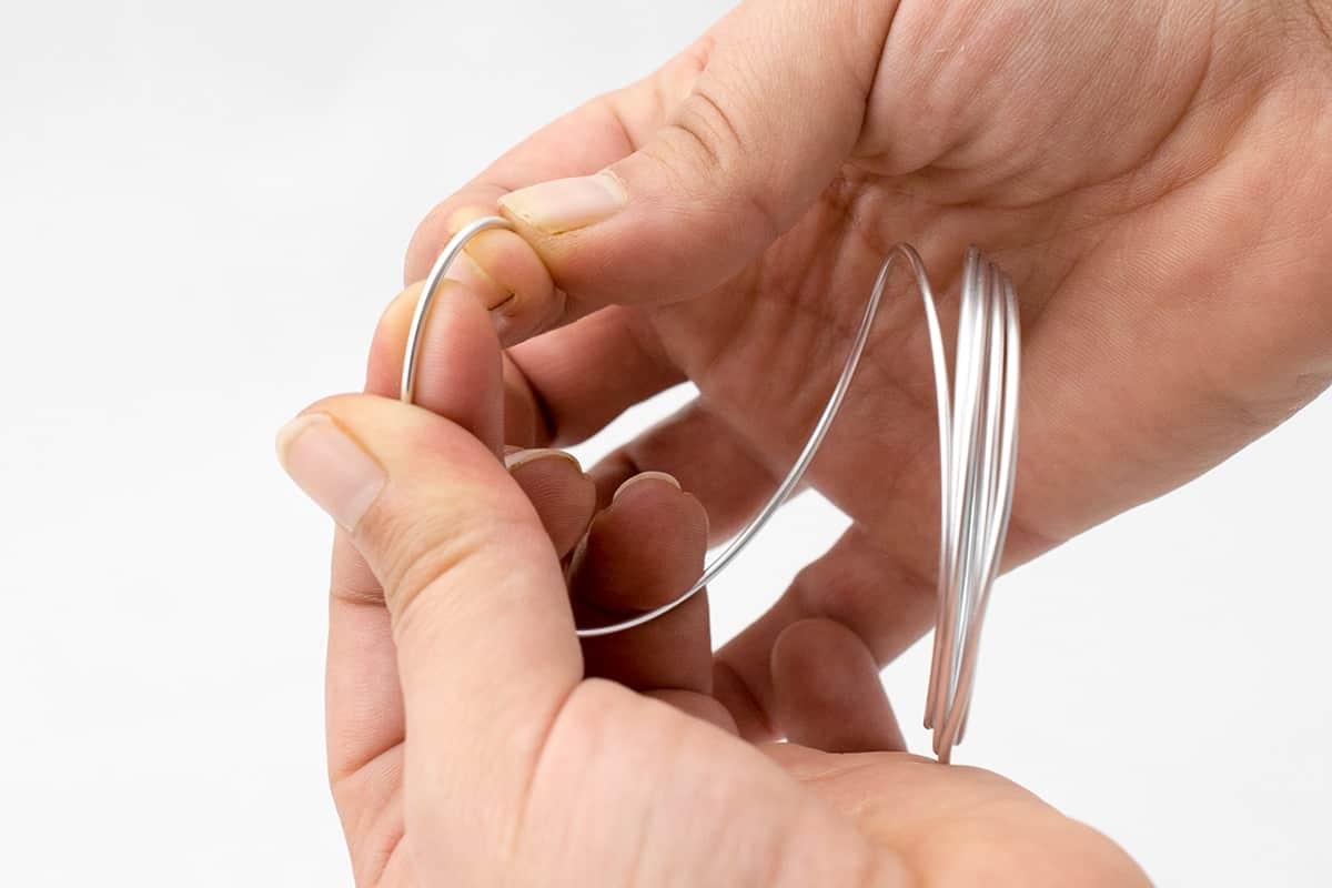 Sixteen gauge soft in hands being folded into shape.