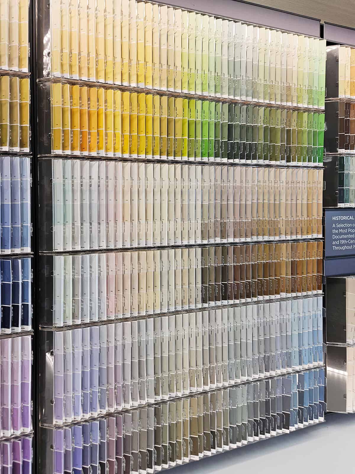 A color collection of paint swatches in a paint store including gray paints.