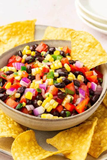 Black bean and corn salsa in a bowl with tortilla chips.