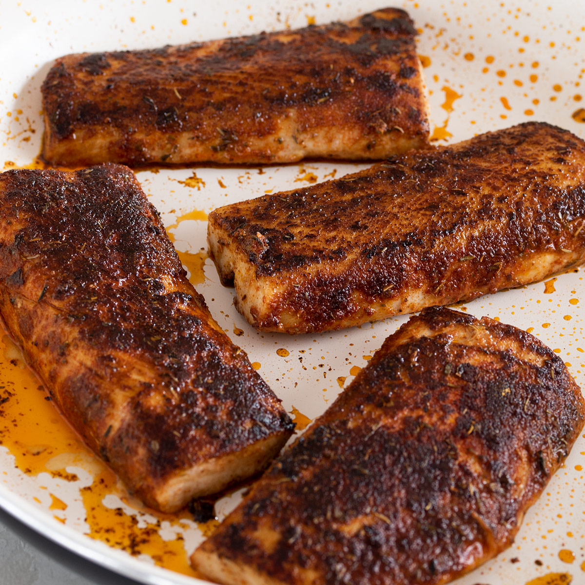 Blackened mahi mahi after cooking in a pan.