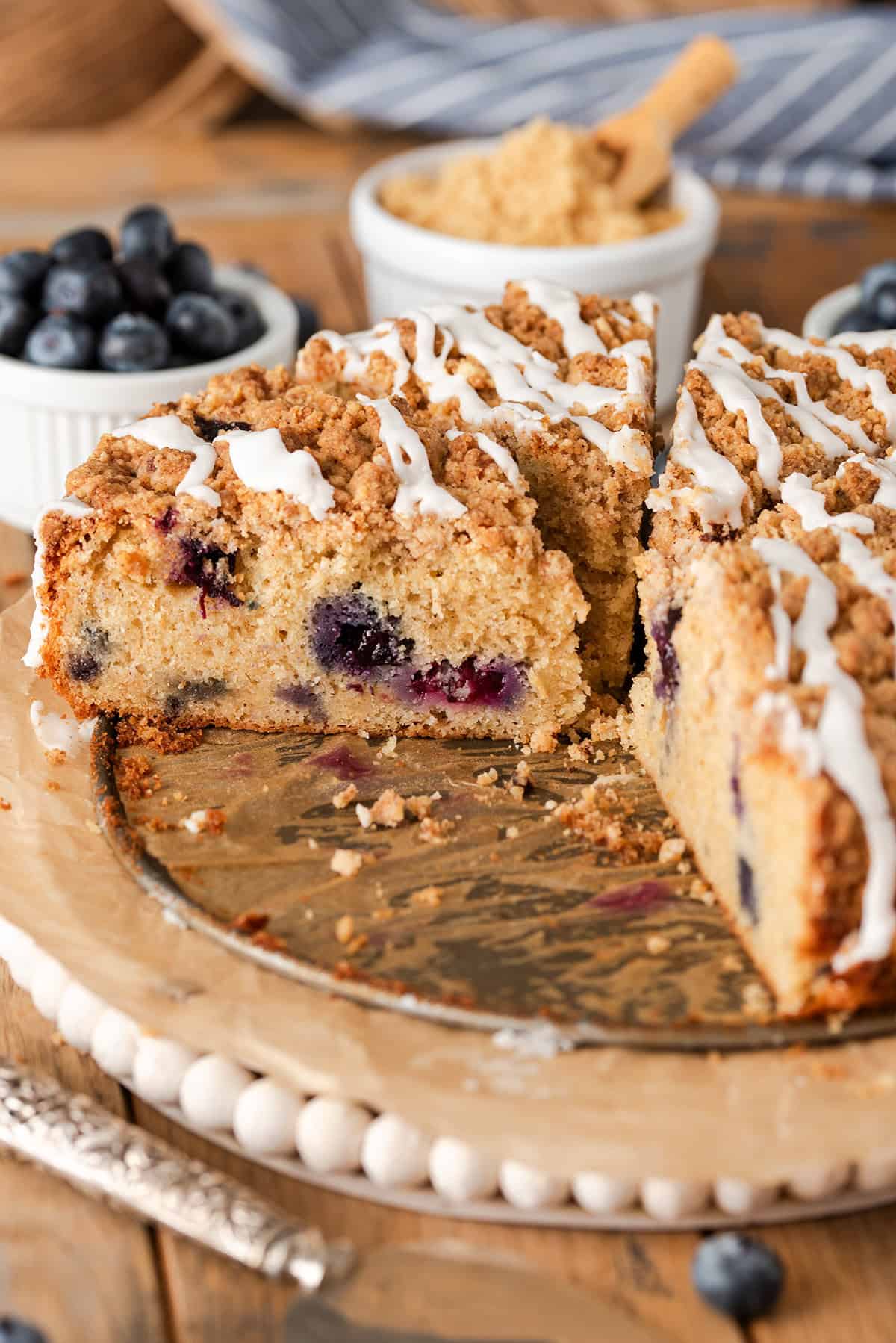 A coffee cake sliced up with one side revealing the inside texture.