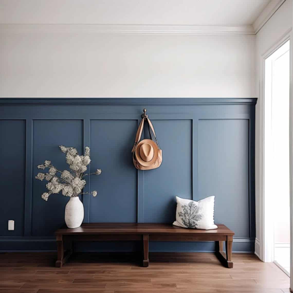 An entryway with blue board and batten wall behind a wood bench.