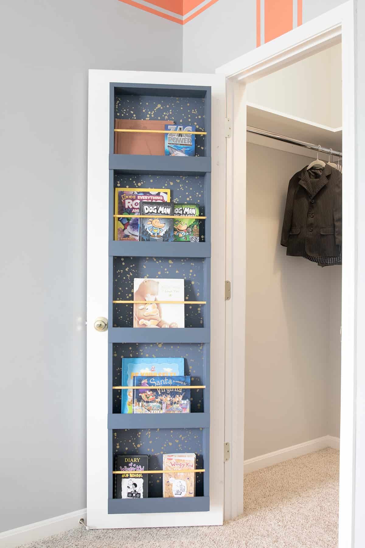 Kids closet organization idea for creating book storage on the back of a door that can be used as shoe storage.
