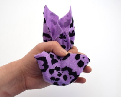 Tucking the center in of napkin to make a face.