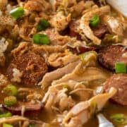 Closeup of chicken and andouille sausage gumbo in a bowl with rice.