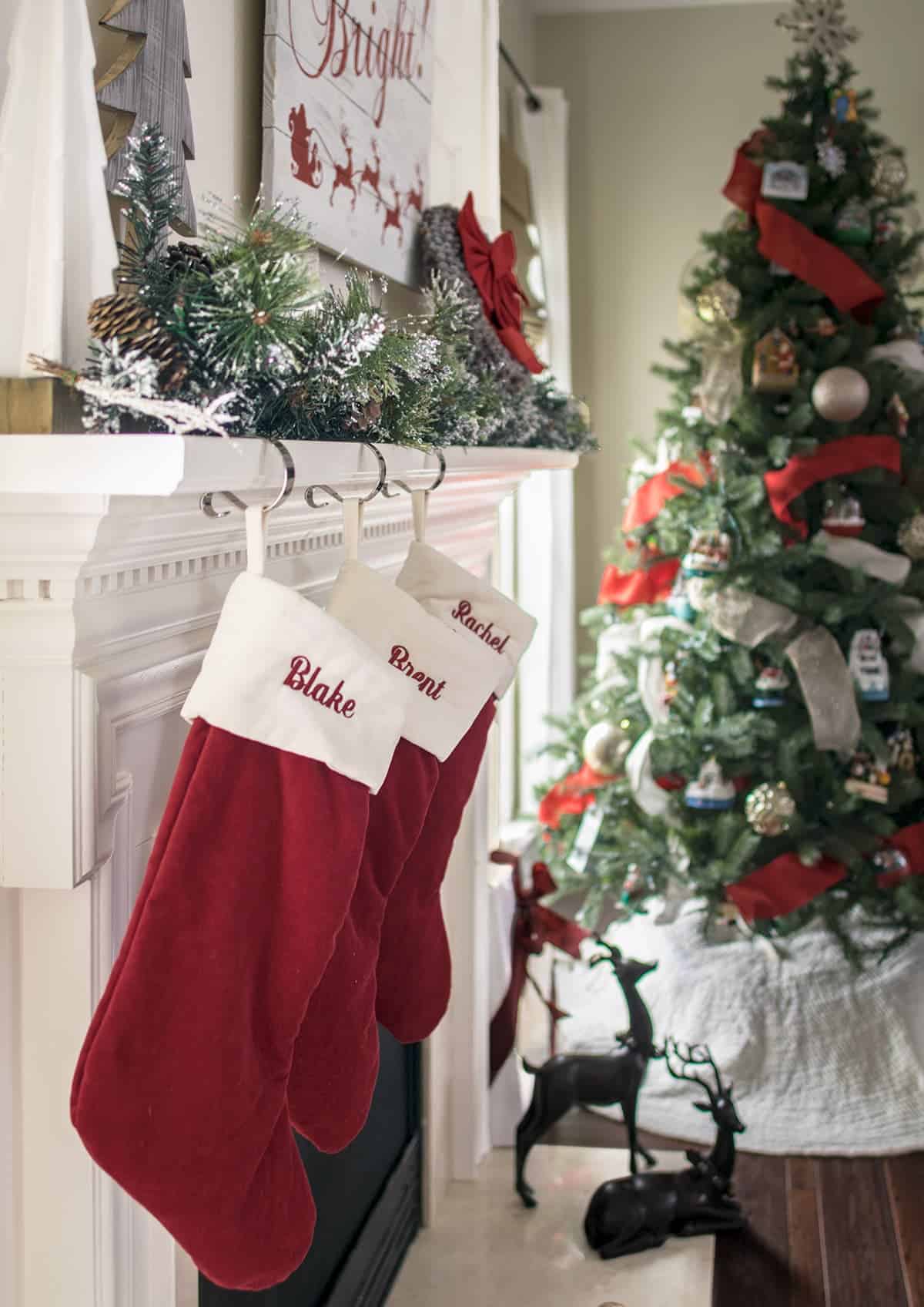 Traditional red christmas stockings hanging from the mantle