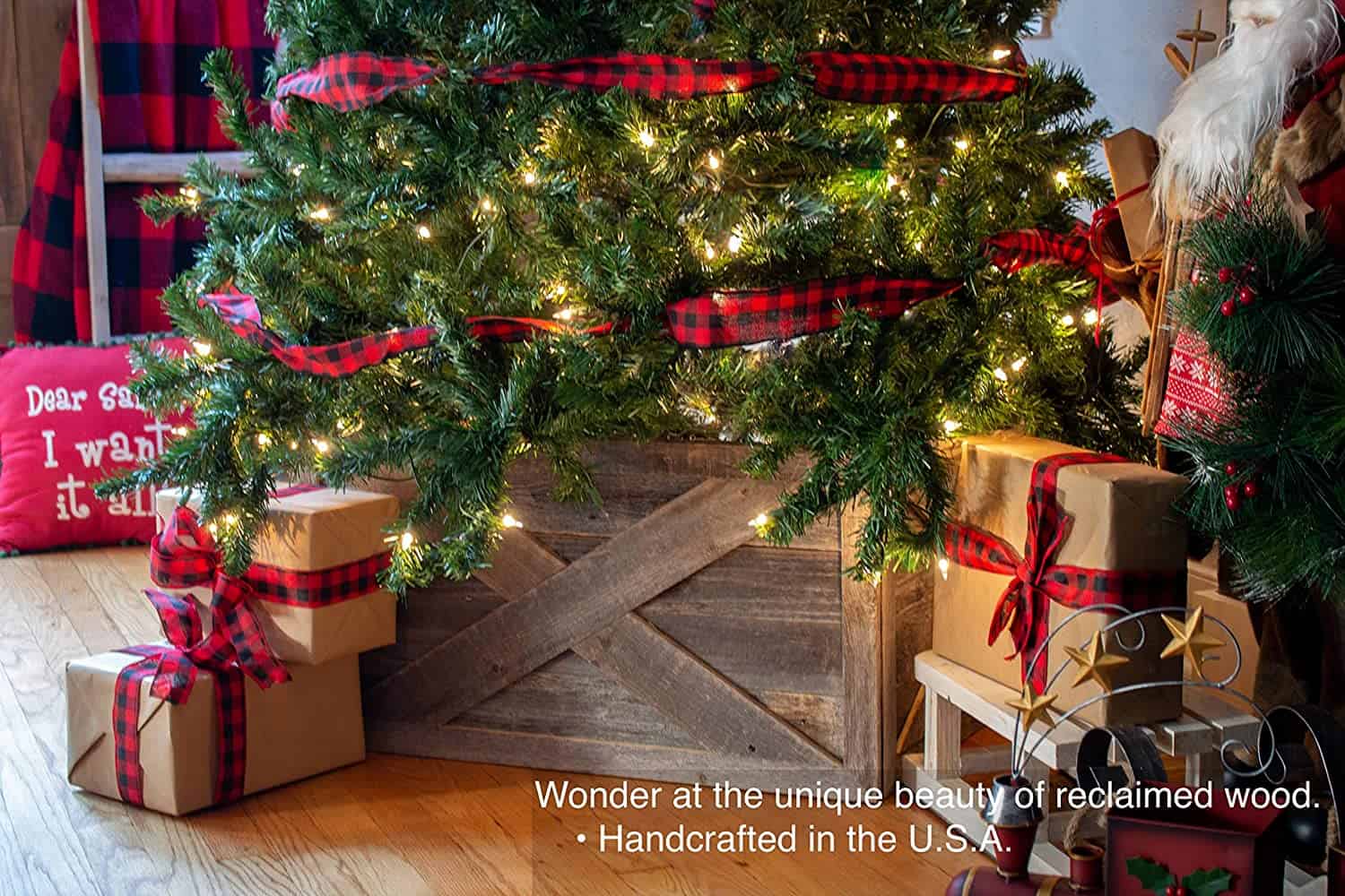 Presents underneath a christmas tree standing in a rustic wood tree stand.