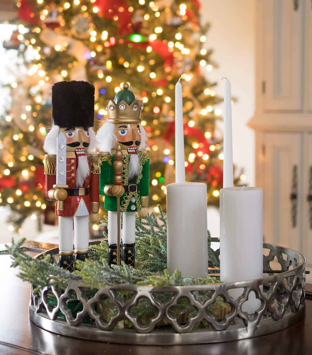 Nutcracker and candle sticks coffee table centerpiece idea with greenery.
