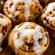 Closeup of apple cinnamon rolls from crescent dough with cream cheese icing on top.