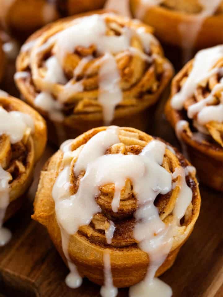 Closeup of apple cinnamon rolls from crescent dough with cream cheese icing on top.