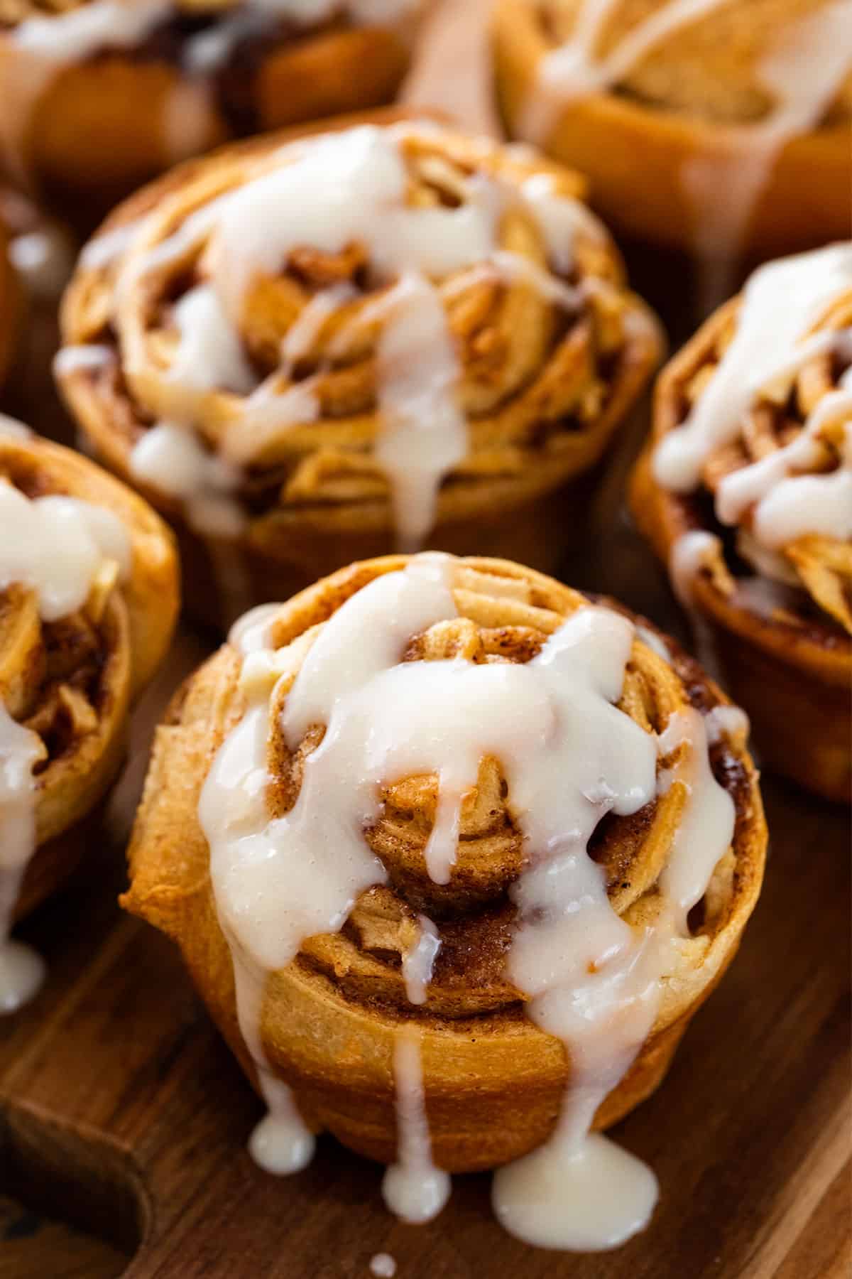 Closeup of apple cinnamon rolls from crescent dough with cream cheese icing on top.