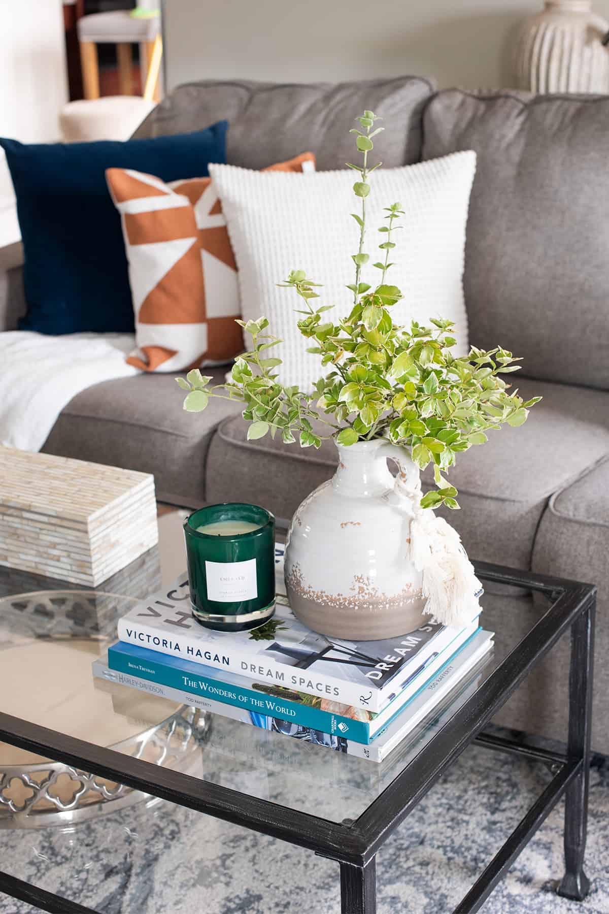 Coffee Table decor with vase, candle, and books.