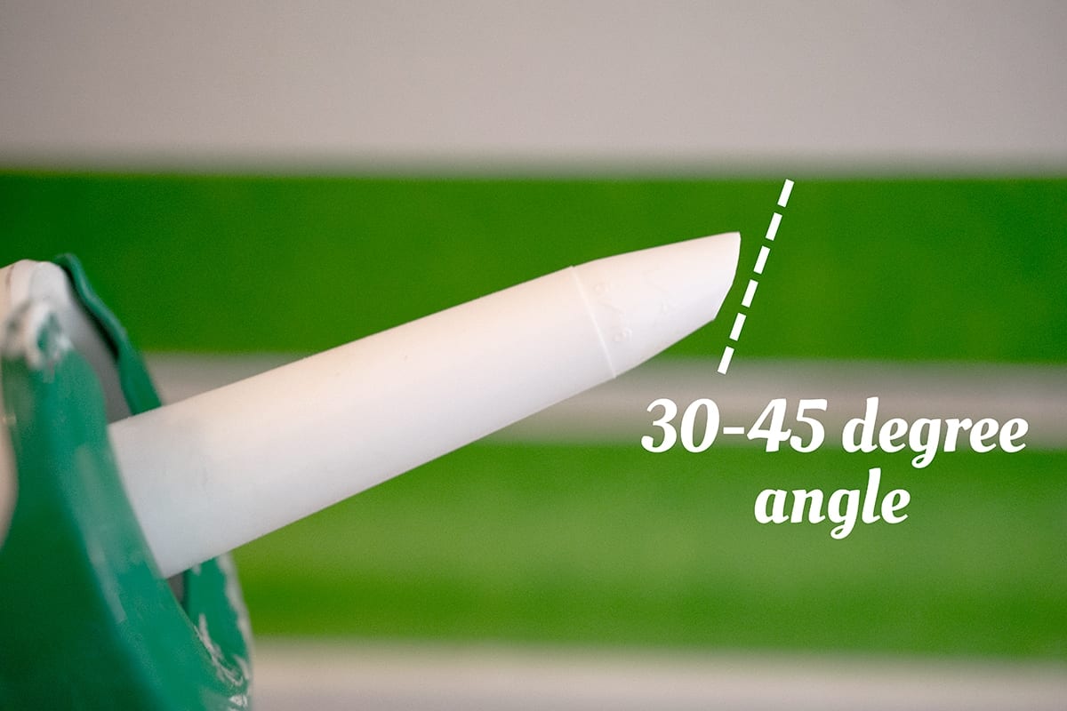 caulking gun with caulking tip cut at a 30-45 degree angle for easier application.
