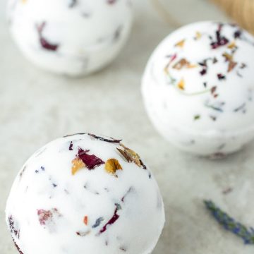 3 Homemade bath bombs with rose petals and lavender inside.