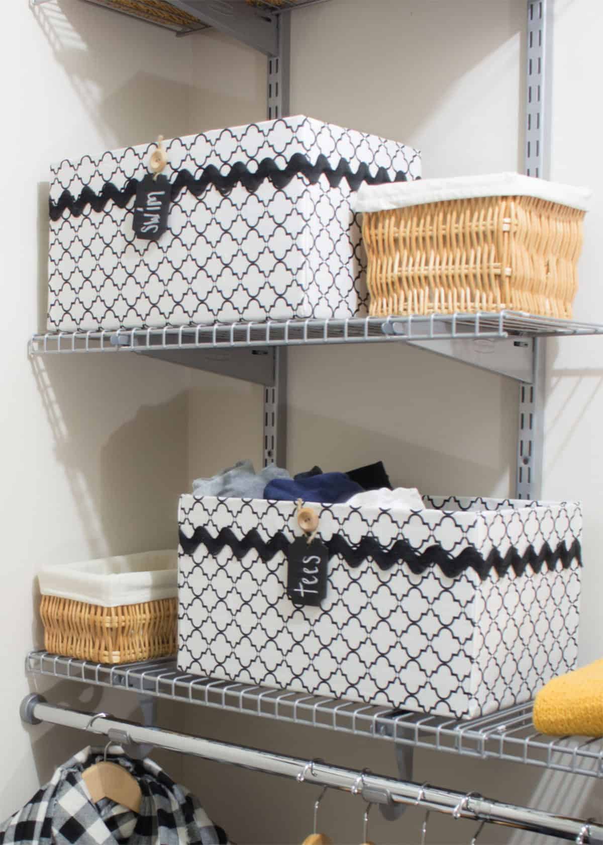 Two white and two wicker baskets on a metal shelf.