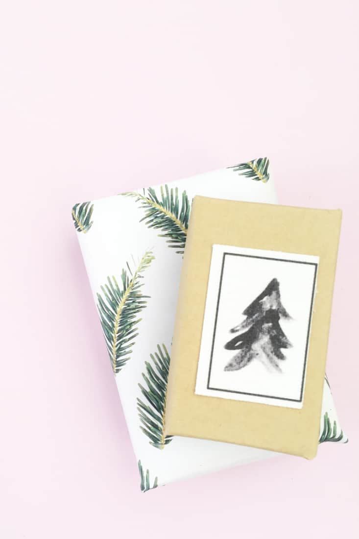 Christmas gifts wrapped with paper printed with pine images.