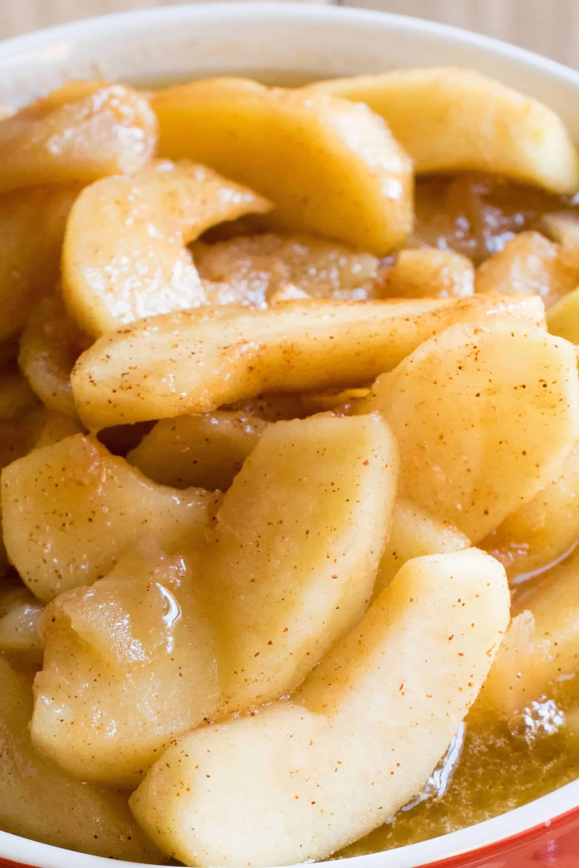 Southern fried apple with cinnamon in red bowl- overhead view.