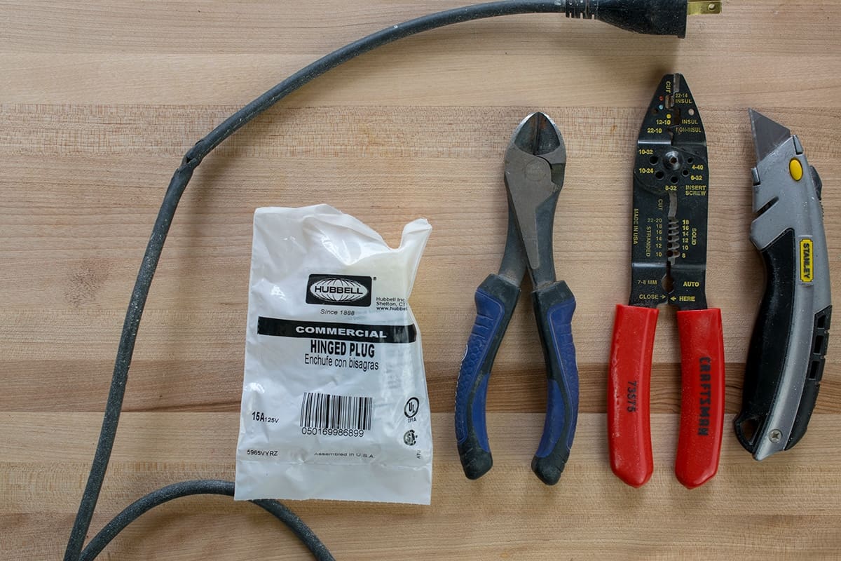 Supplies for fixing extension cords including wire cutters, wire strippers, and replacement plug.