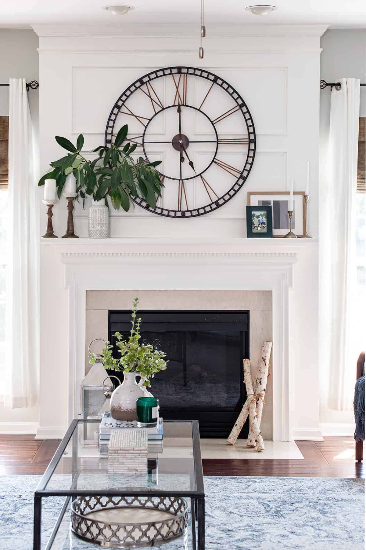 Fireplace mantle picture frame trim decoration with oversized clock.