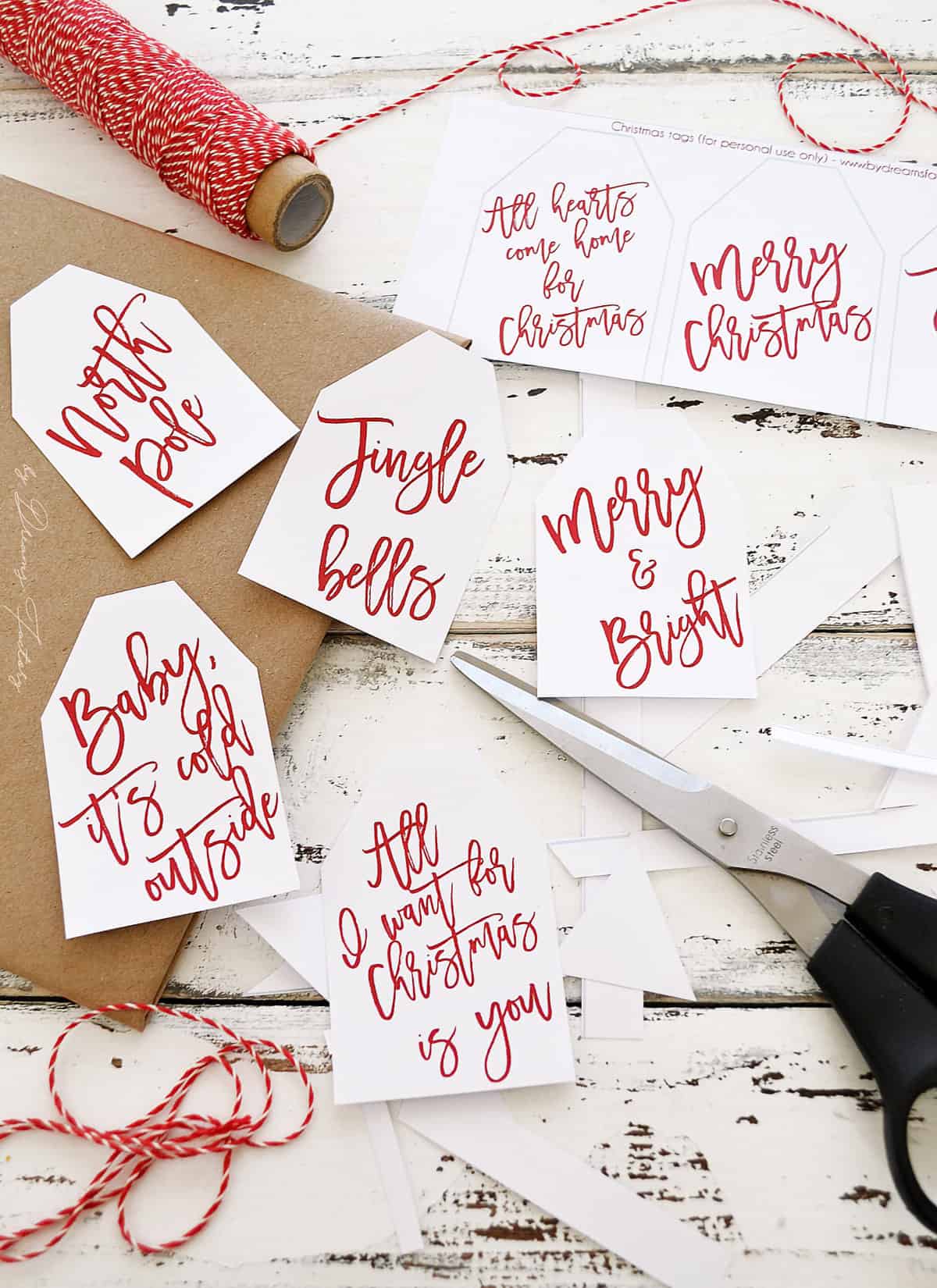 Handwritten red and white Christmas tags scattered on a white background.