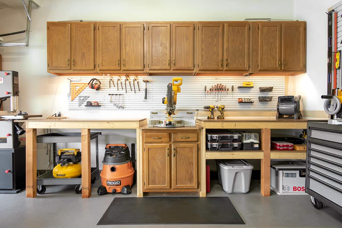 Garage woodworking workshop with cabinets, workbench, and lots of tool storage in a clean and organized garage.