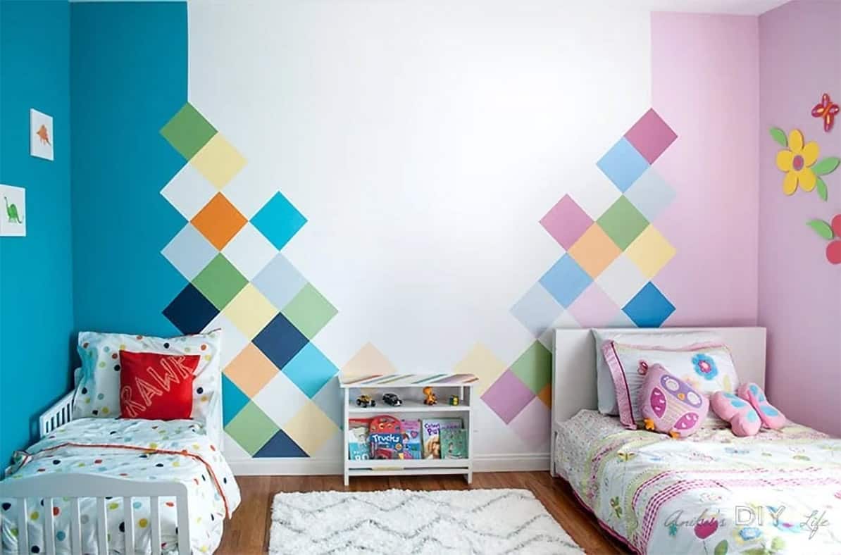 Colorful DIY Geometric painted accent wall in a whimsical unisex children's bedroom decorating.