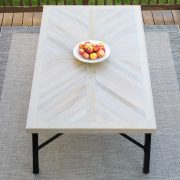 Wood farmhouse table in X cross or herringbone pattern with black legs.