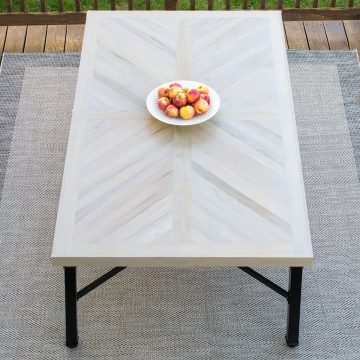 Wood farmhouse table in X cross or herringbone pattern with black legs.