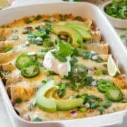Green Chicken Enchiladas in a casserole pan.