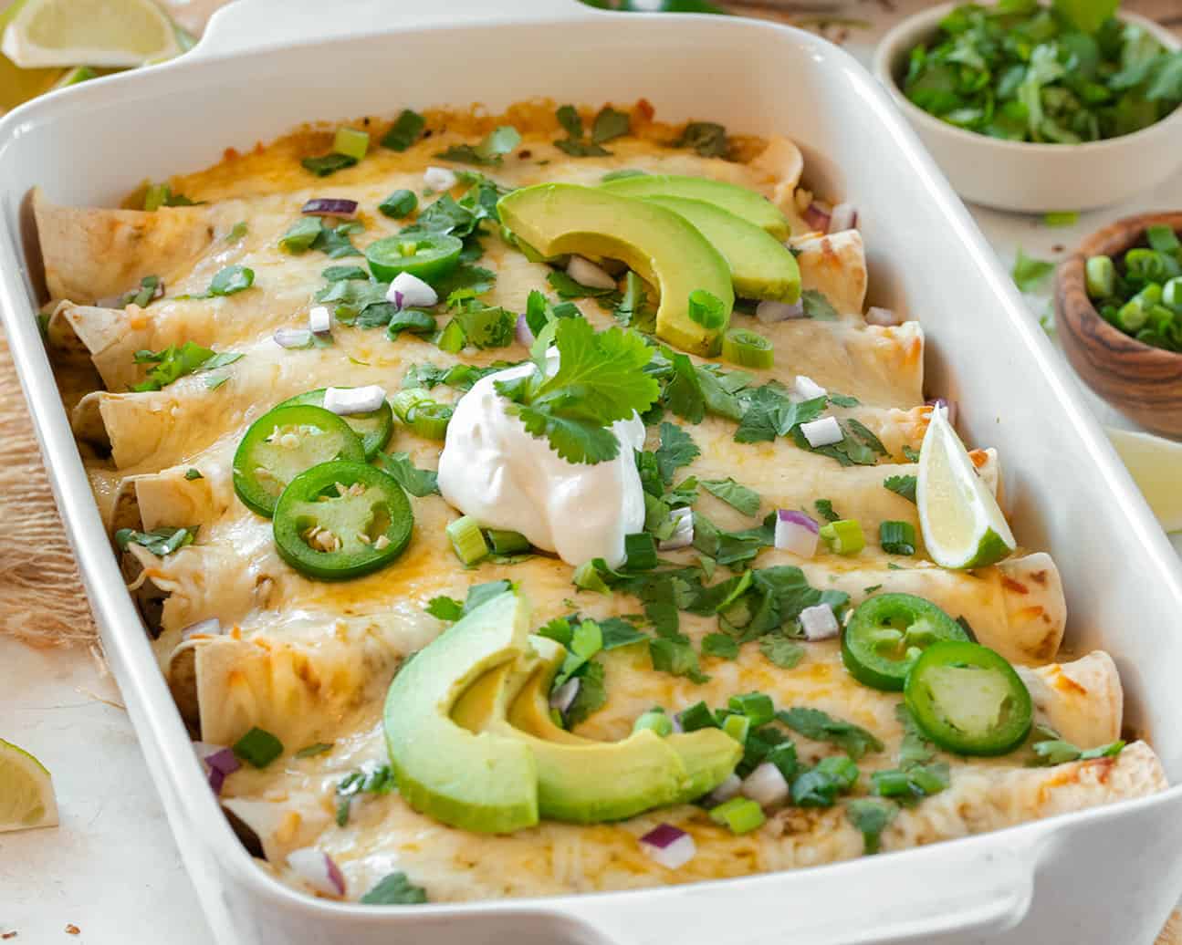 Green Chicken Enchiladas in a casserole pan.