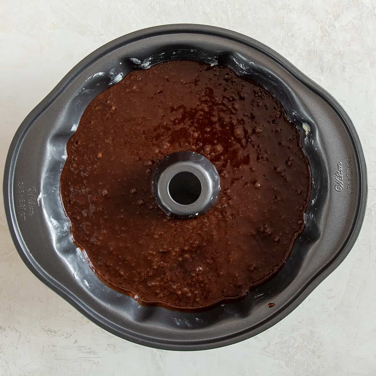 Chocolate cake batter in a floured bundt pan before going in the oven.