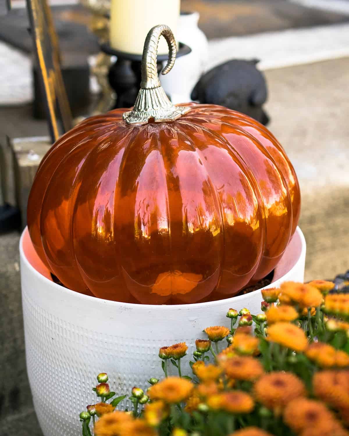 Glass Pumpkin Outdoor Decoration and orange mum.