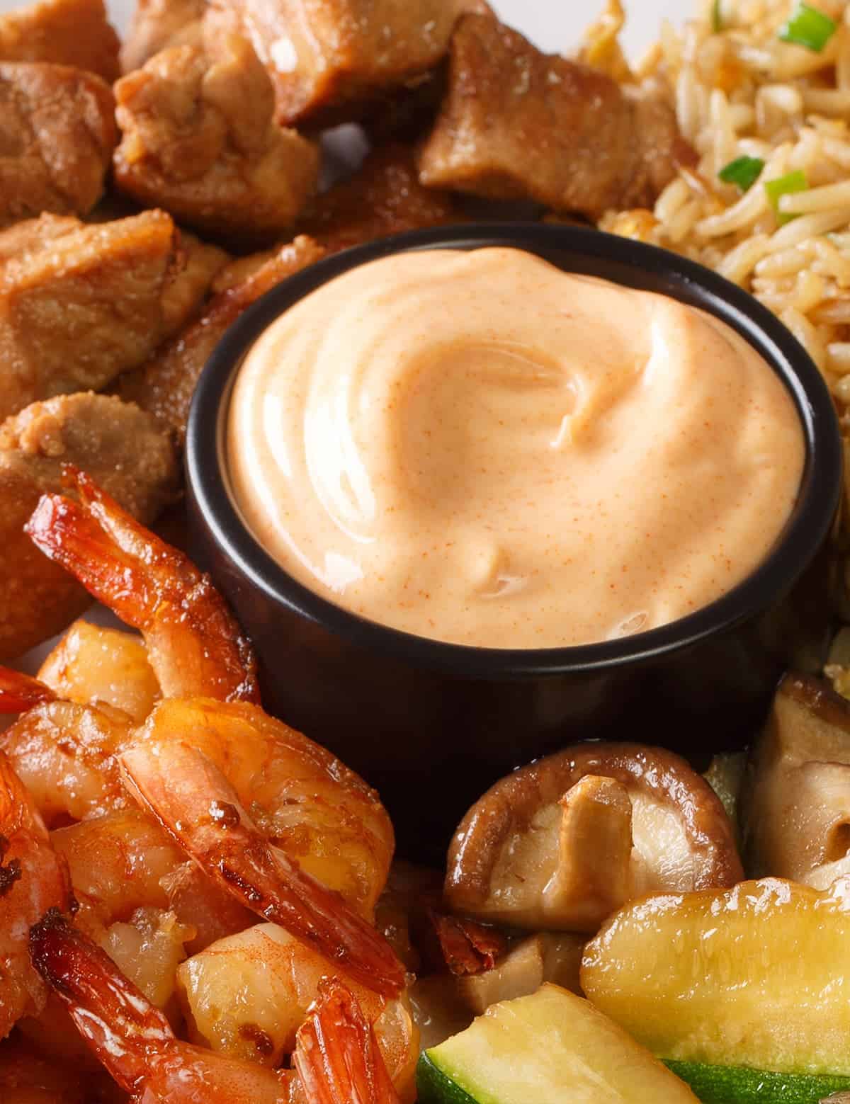 Seasoned shrimp and diced chicken hibachi with zucchini, mushrooms, and fried rice with cup of yum yum sauce.