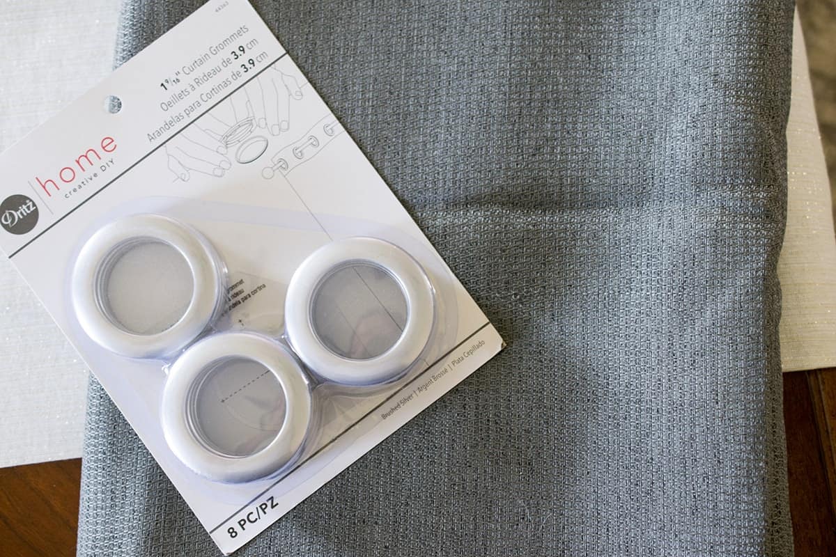 Flat lay of a blackout curtain with a package of eyelets on top.