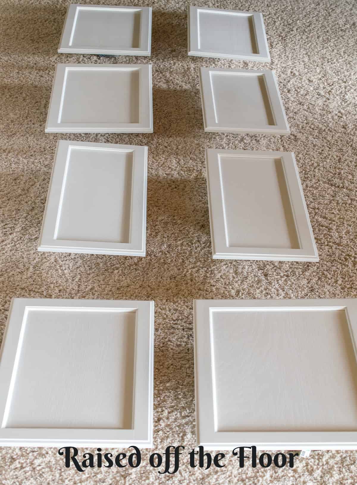 Freshly painted cabinet doors laid out off the floor for drying.