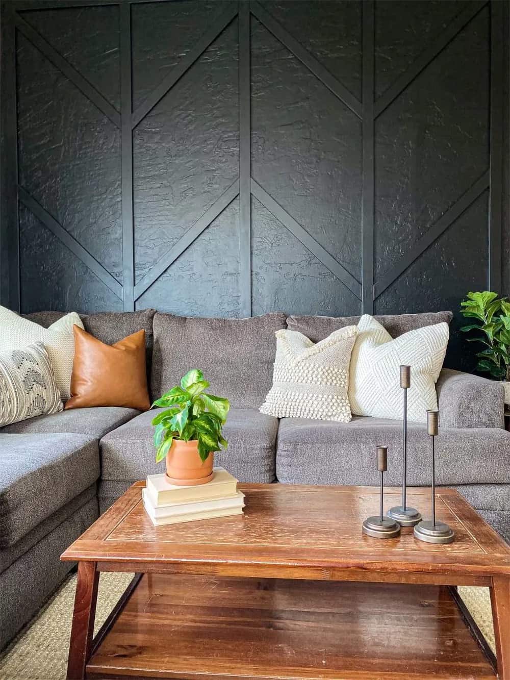 Living room with black geometric wall.