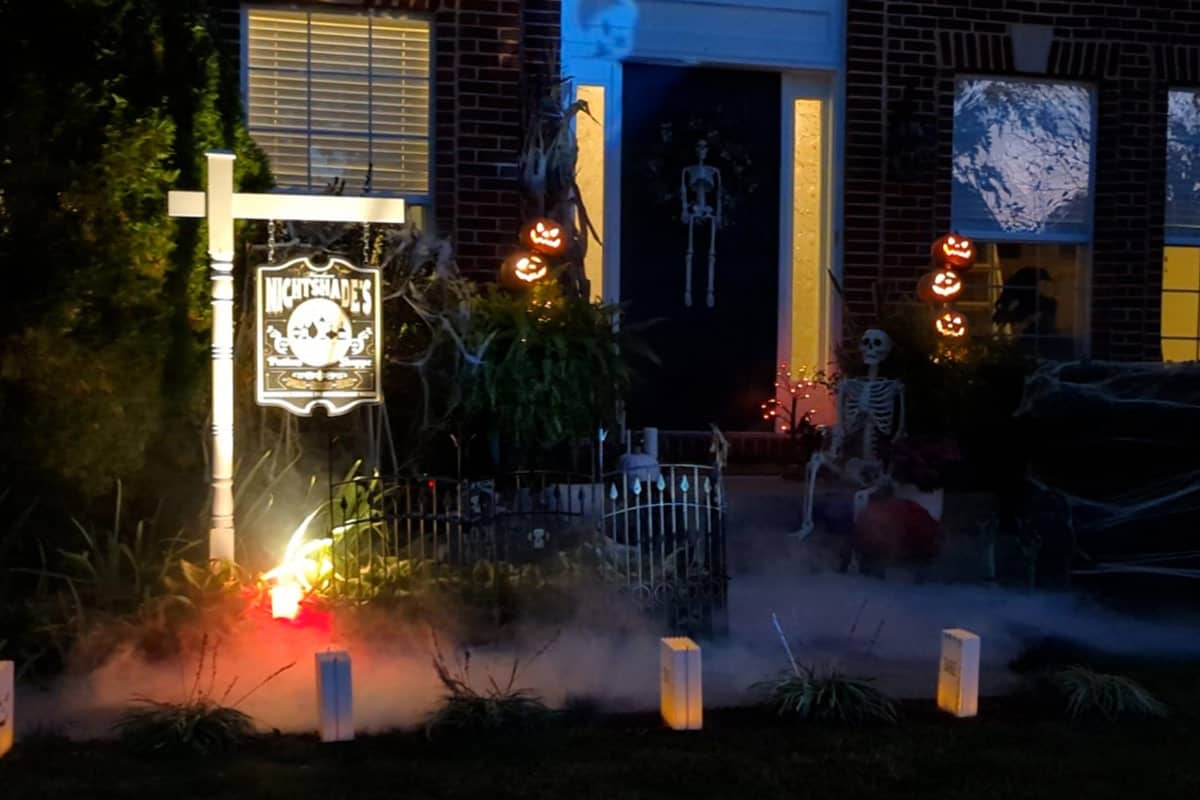Creepy Halloween decorations lit up on halloween night.