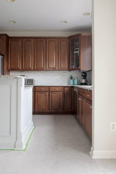 Kitchen with dark wood cabinets and grey vinyl floor tile.