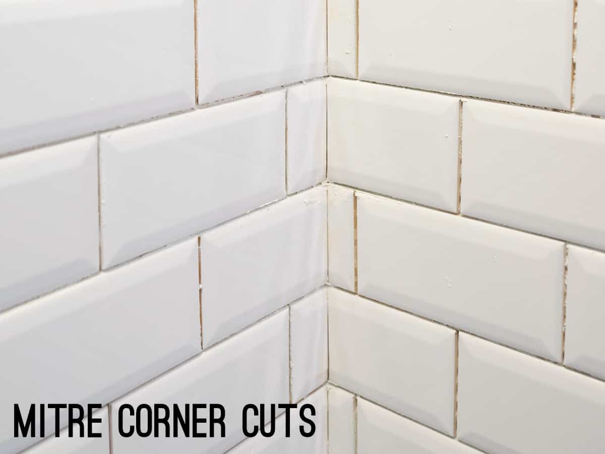 Miter cuts in corners of white subway tiles.