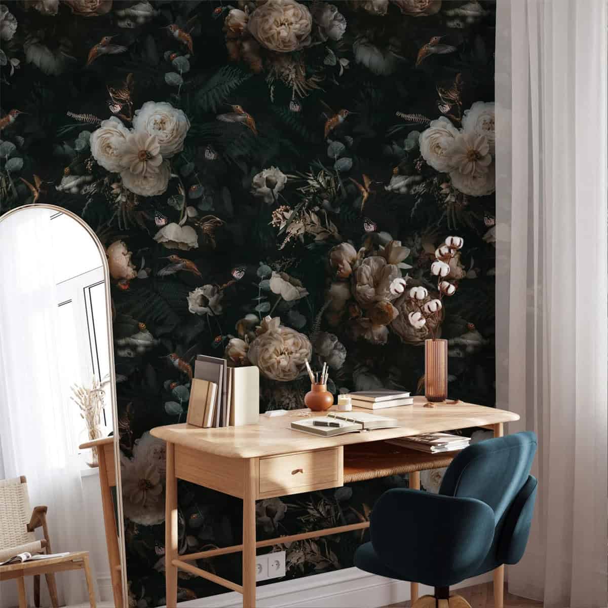 Teal desk chair and natural desk pointed at a floral wallpapered wall.