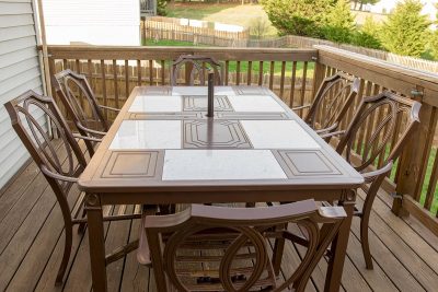 Brown outdoor dining table with 6 chairs.