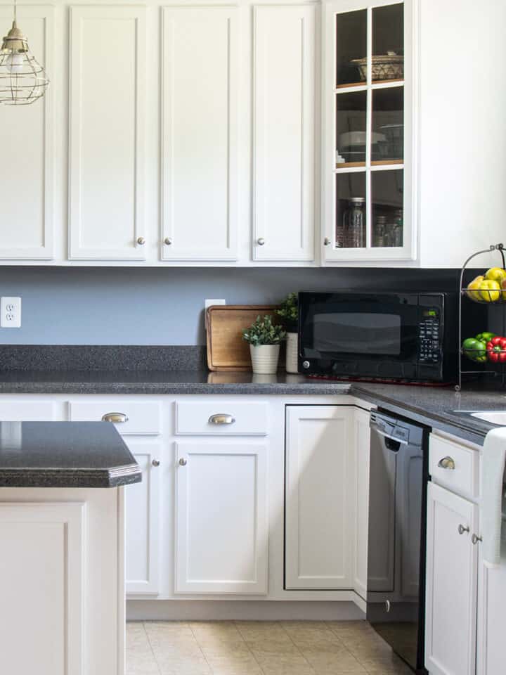 Painting cabinets without sanding or priming in a white kitchen.