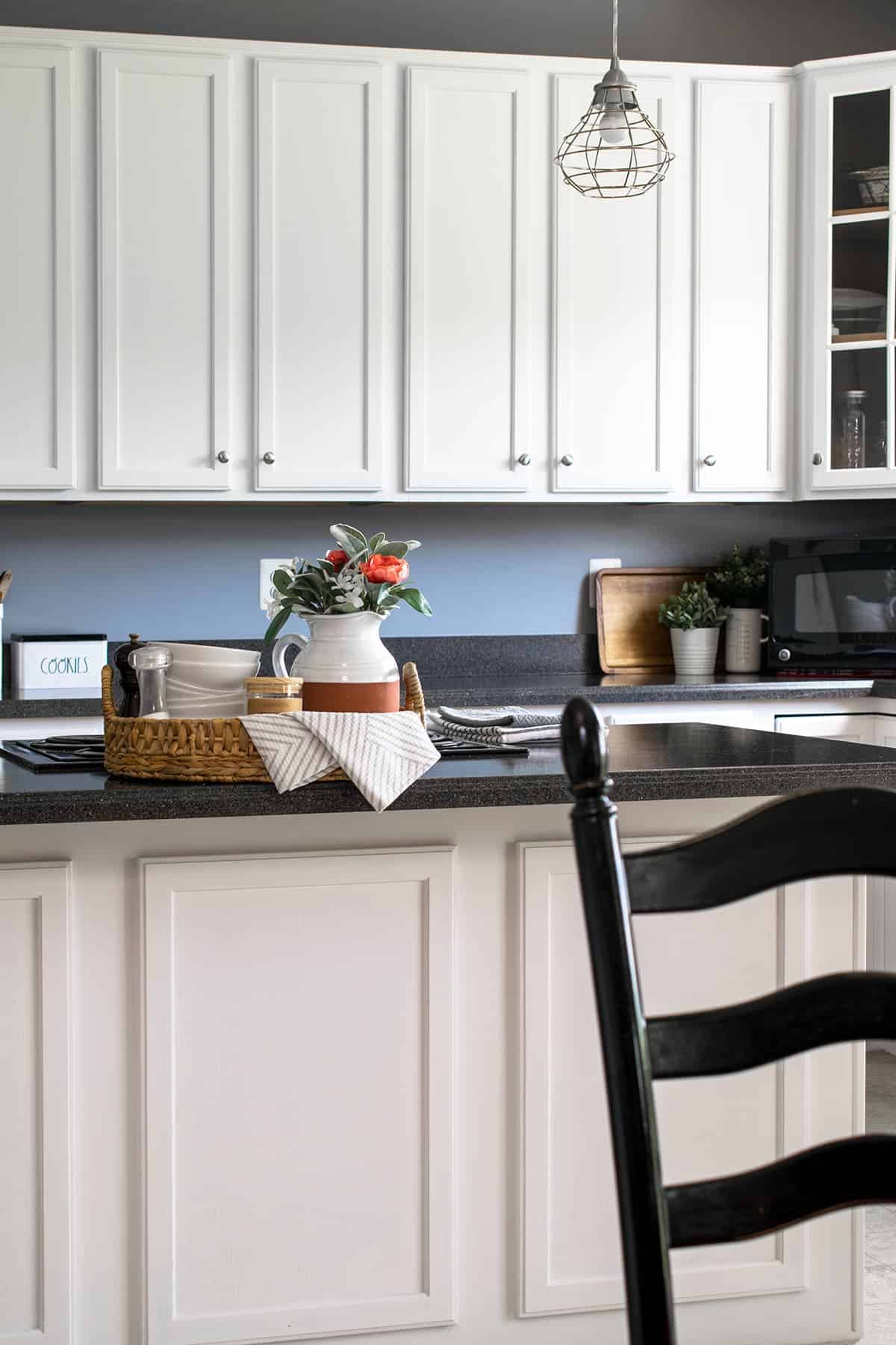White painted kitchen cabinets with silver hardware.