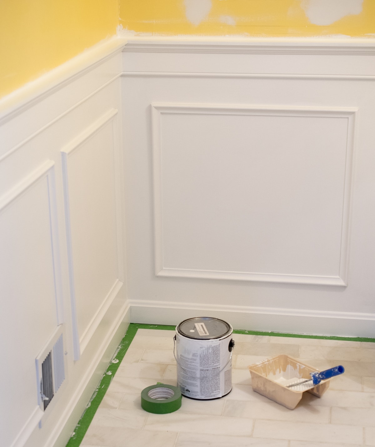 Completed white wainscoting added to walls in bathroom.