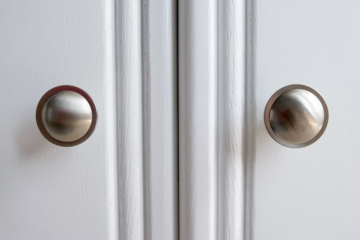 Cabinets on captain's bed with fresh coat of white paint and satin nickel drawer pulls.