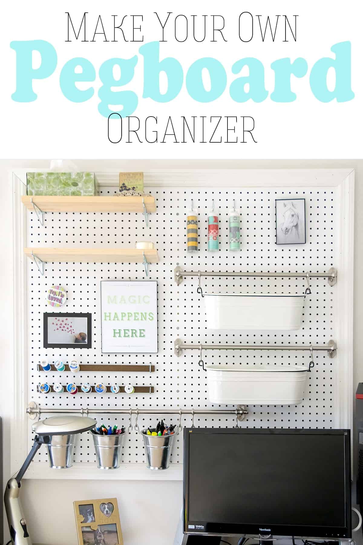 Large white pegboard on wall for craft supply storage hanging over computer desk area.