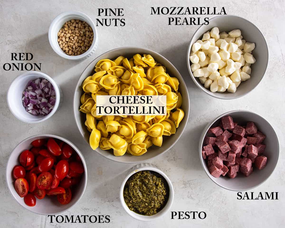 The ingredients for cheese tortellini in bowls with labels.